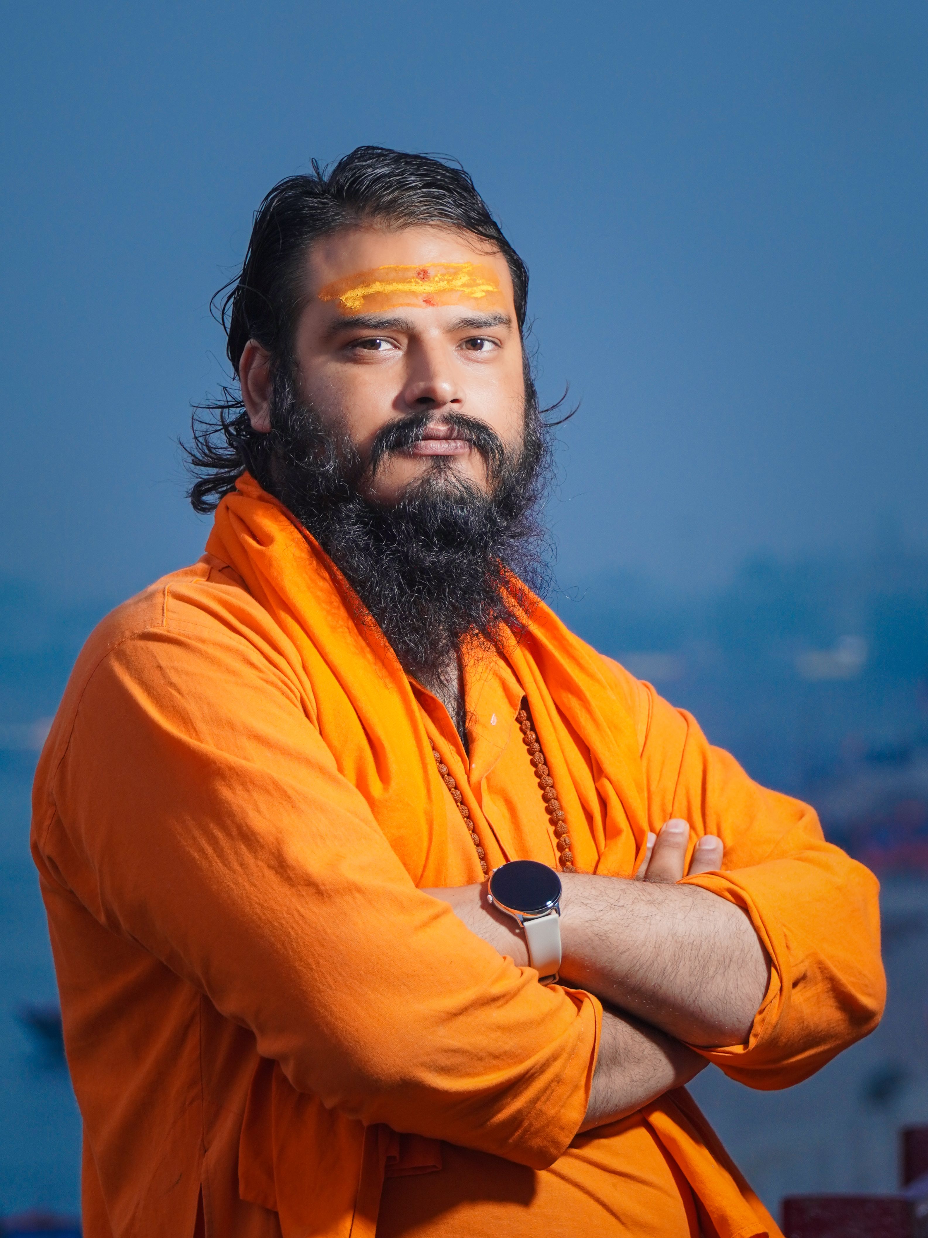 A traditional Hindu holy man, or sadhu, stands by the Ganges in Varanasi.