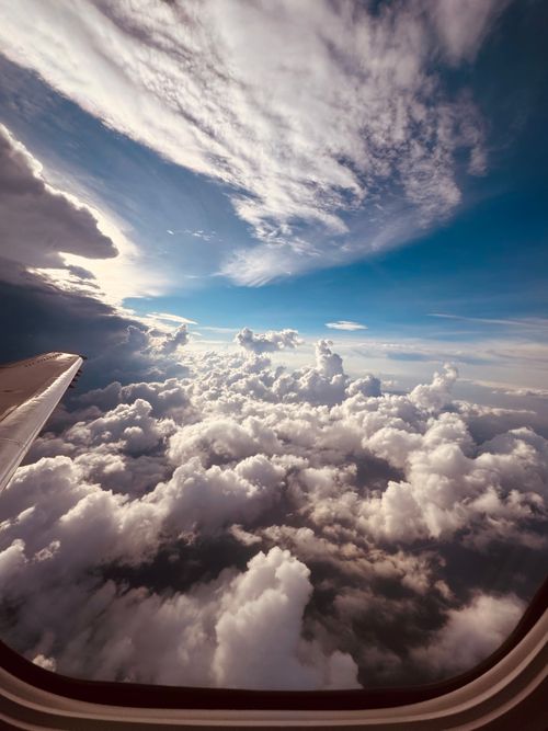 Free stock photo of above clouds, above the clouds, airplane window Stock Photo