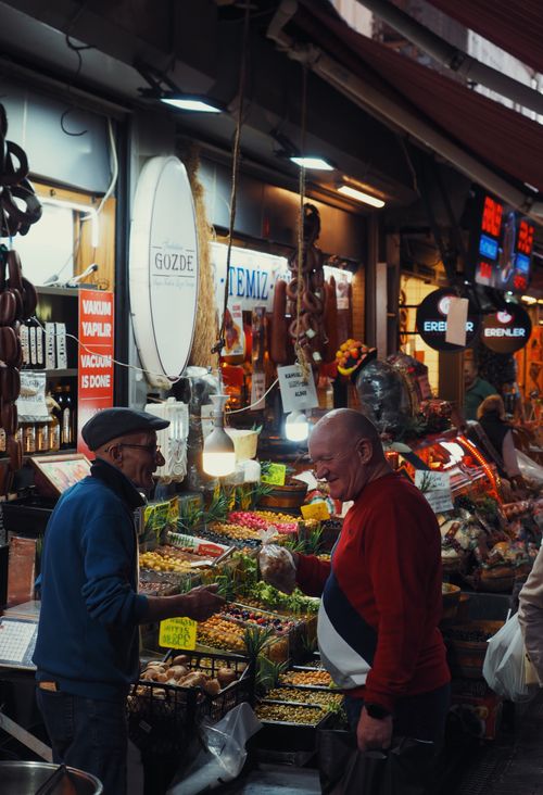 Free Vibrant interaction at Istanbul's Spice Bazaar, showcasing diverse spices and friendly vendors. Stock Photo