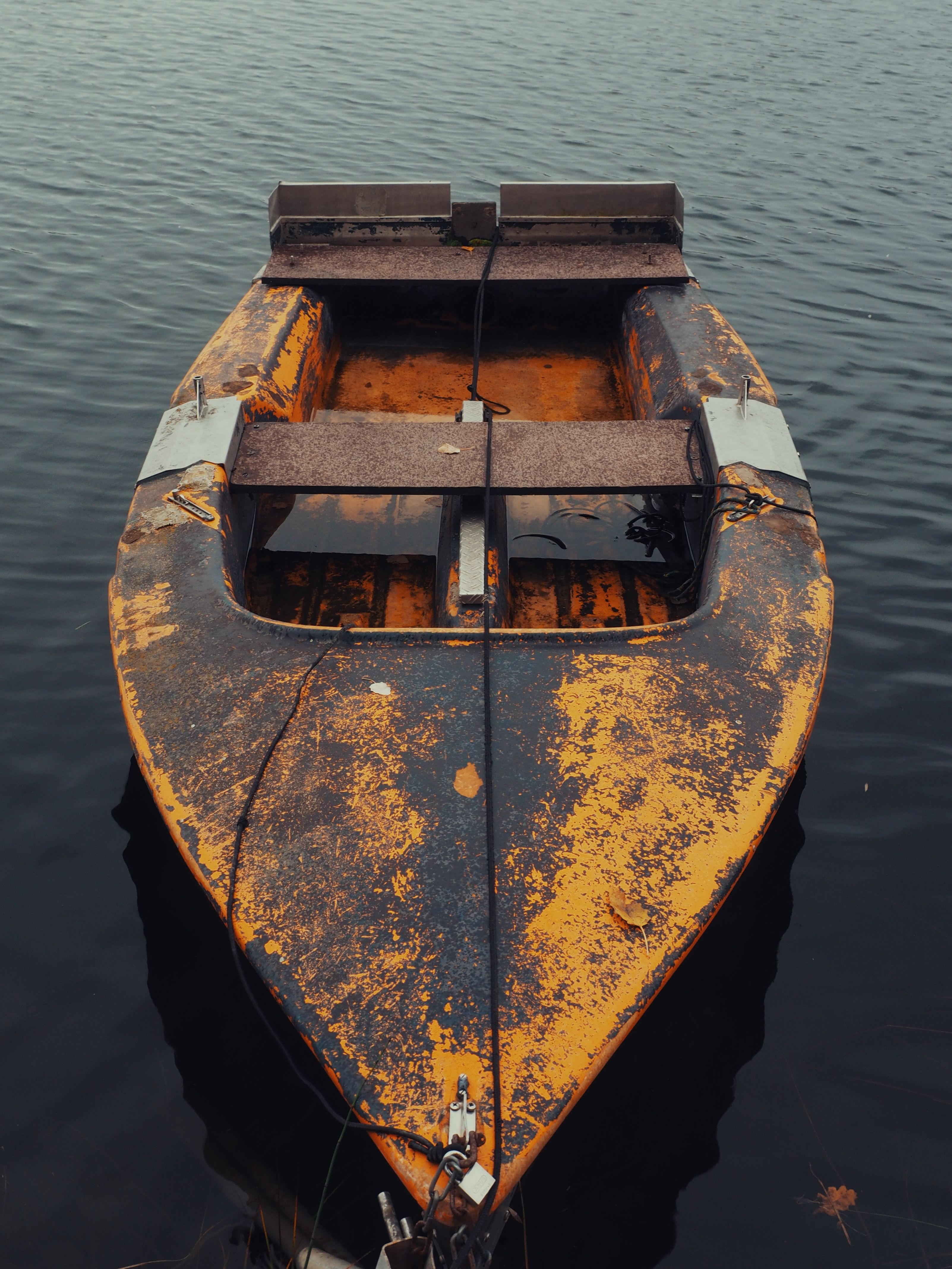 Rusty Abandoned Boat on Calm Water Surface · Free Stock Photo