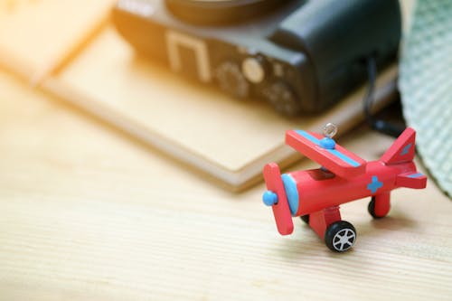 Free Red Biplane Toy on Wooden Surface Stock Photo