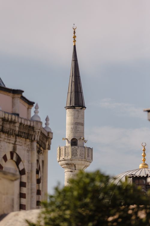 Free A detailed view of a minaret in Istanbul under a clear blue sky, showcasing its architectural beauty. Stock Photo
