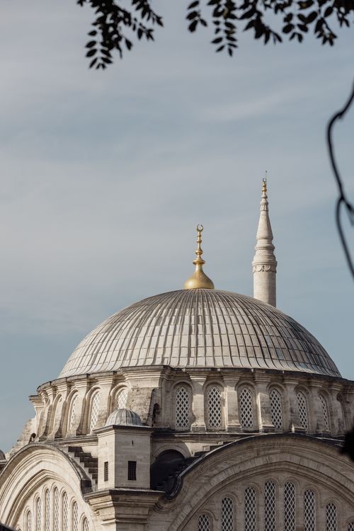 Free A stunning view of a mosque dome with a golden crescent under a clear sky. Stock Photo