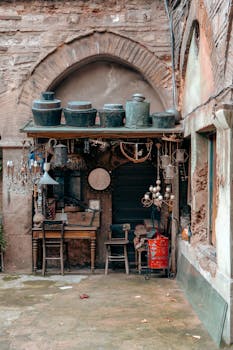 Charming vintage shop in a historic Istanbul courtyard, showcasing rustic decor and antiques.