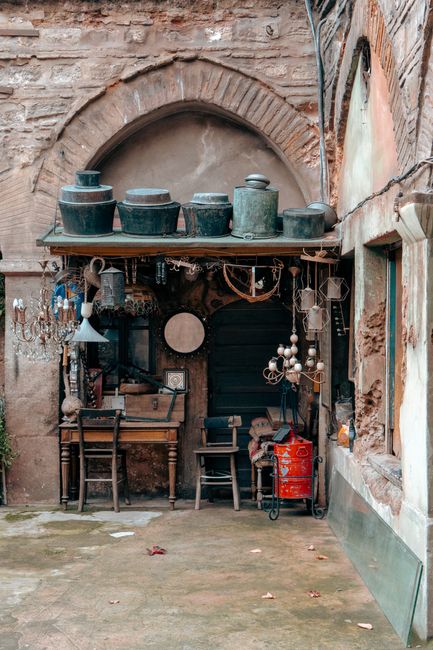 Charming vintage shop in a historic Istanbul courtyard, showcasing rustic decor and antiques.