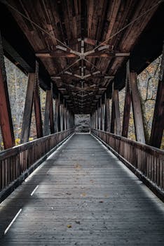 Wooden covered bridge with rustic charm and autumn ambiance.