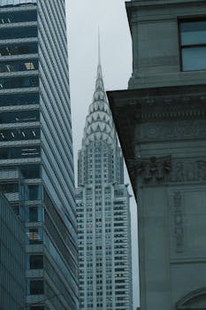 Iconic Chrysler Building seen through surrounding architecture in New York City.