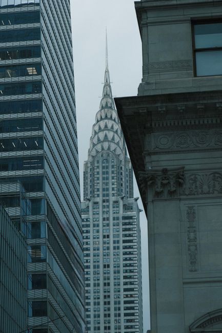 Iconic Chrysler Building seen through surrounding architecture in New York City.