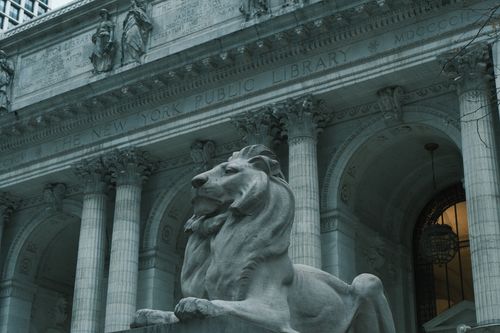 Free Statue of a lion at the New York Public Library, a classic architectural landmark. Stock Photo