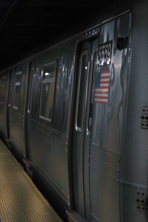Free A sleek subway train at a station with American flag decal in New York City. Stock Photo