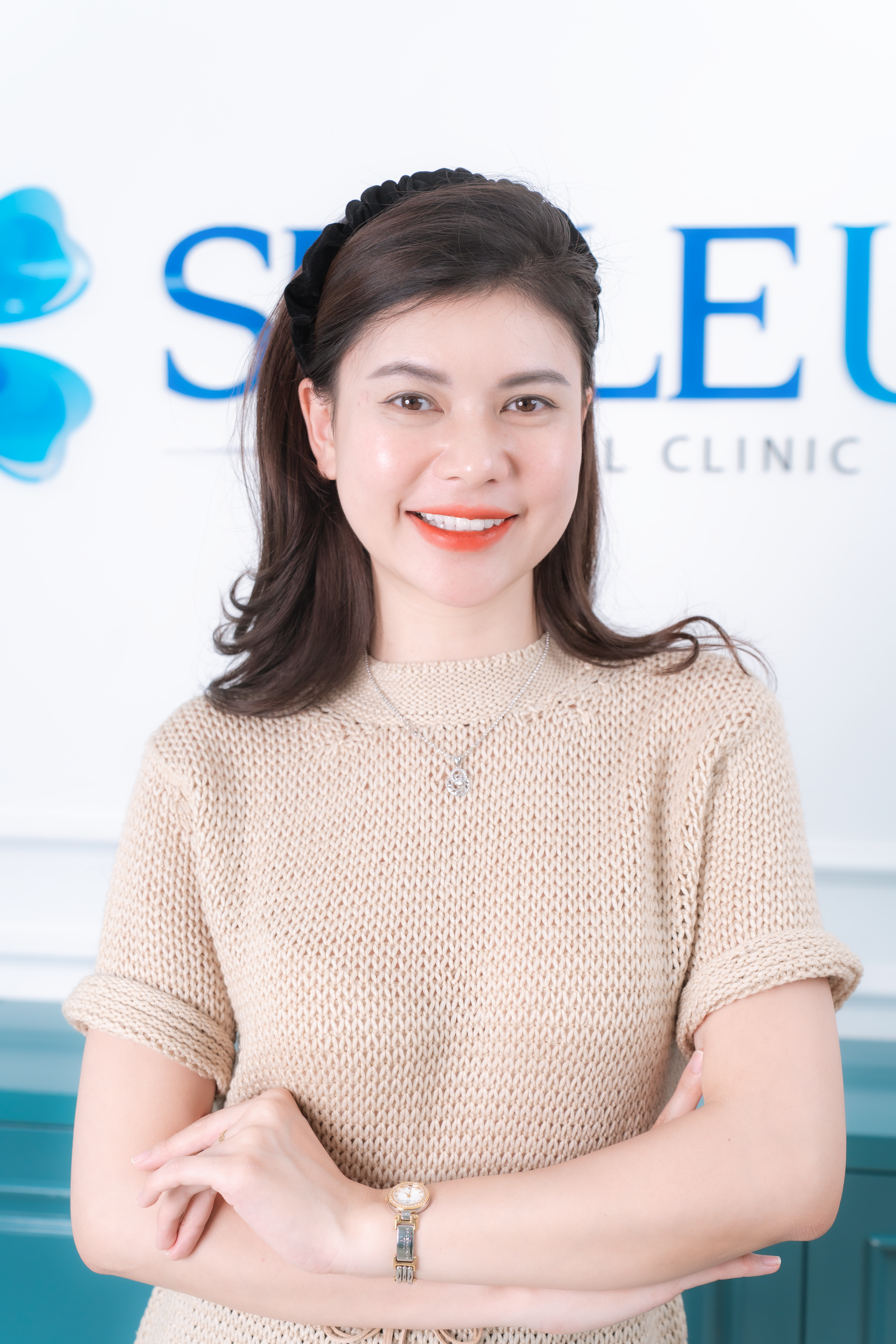 Portrait of smiling woman in dental clinic for professionalism.