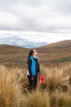 A woman gazes up at the sky amidst the beautiful Andean landscape in Ecuador.