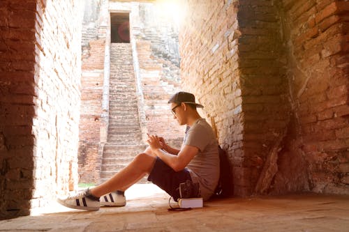 Man Sitting Beside Stair