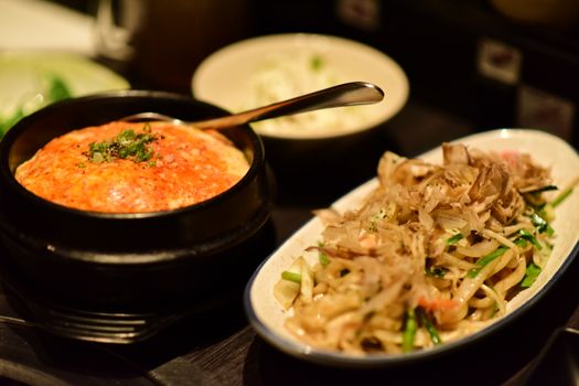 Tantalizing Japanese cuisine featuring a flavorful ramen and rice dish served in bowls.