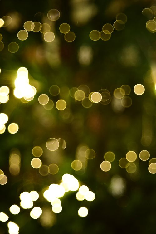 Free Abstract image of warm sparkling bokeh lights in a dark setting, ideal for festive occasions. Stock Photo