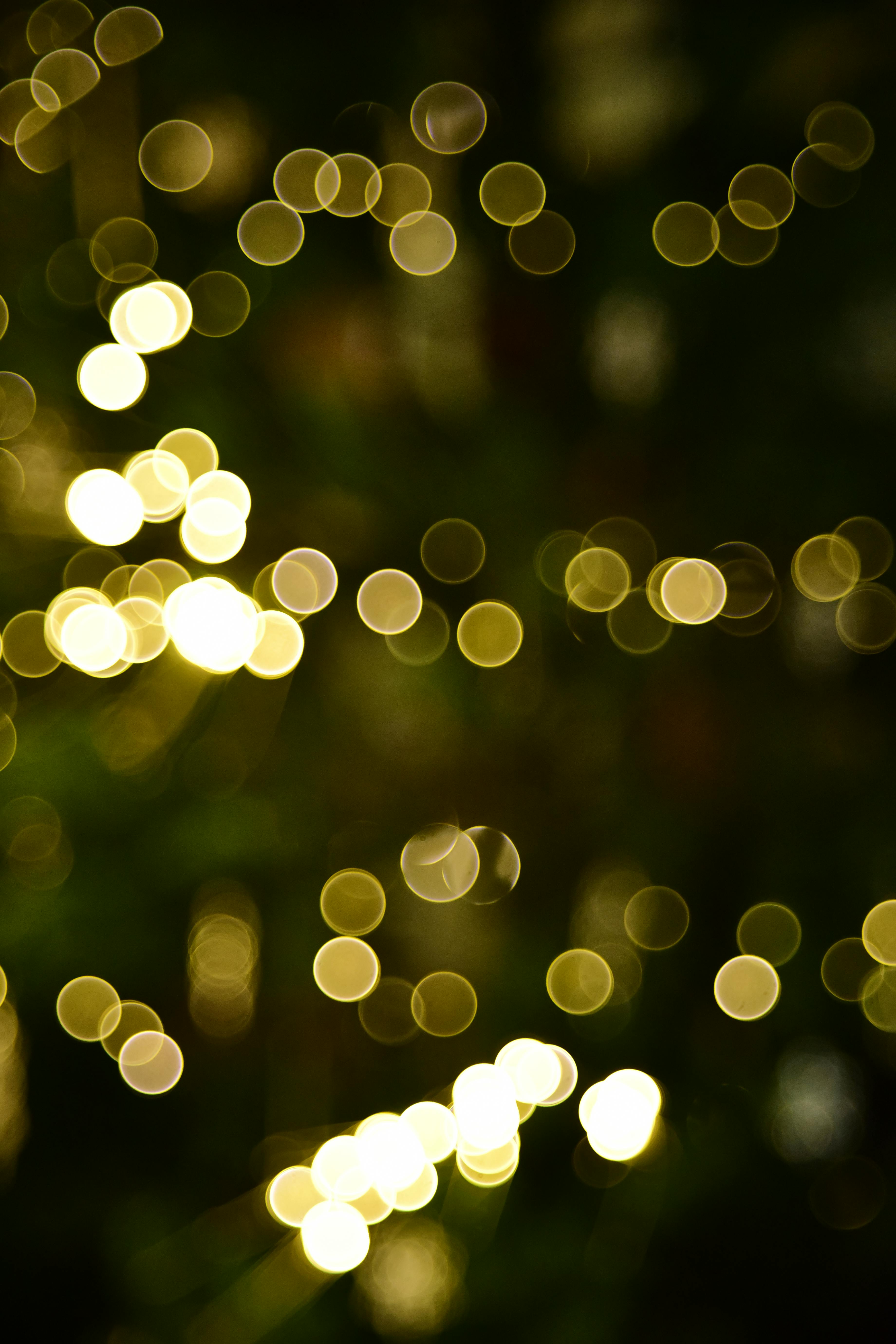 Abstract golden bokeh lights creating a festive and warm atmosphere, perfect for holiday designs.