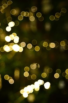 Abstract golden bokeh lights creating a festive and warm atmosphere, perfect for holiday designs.