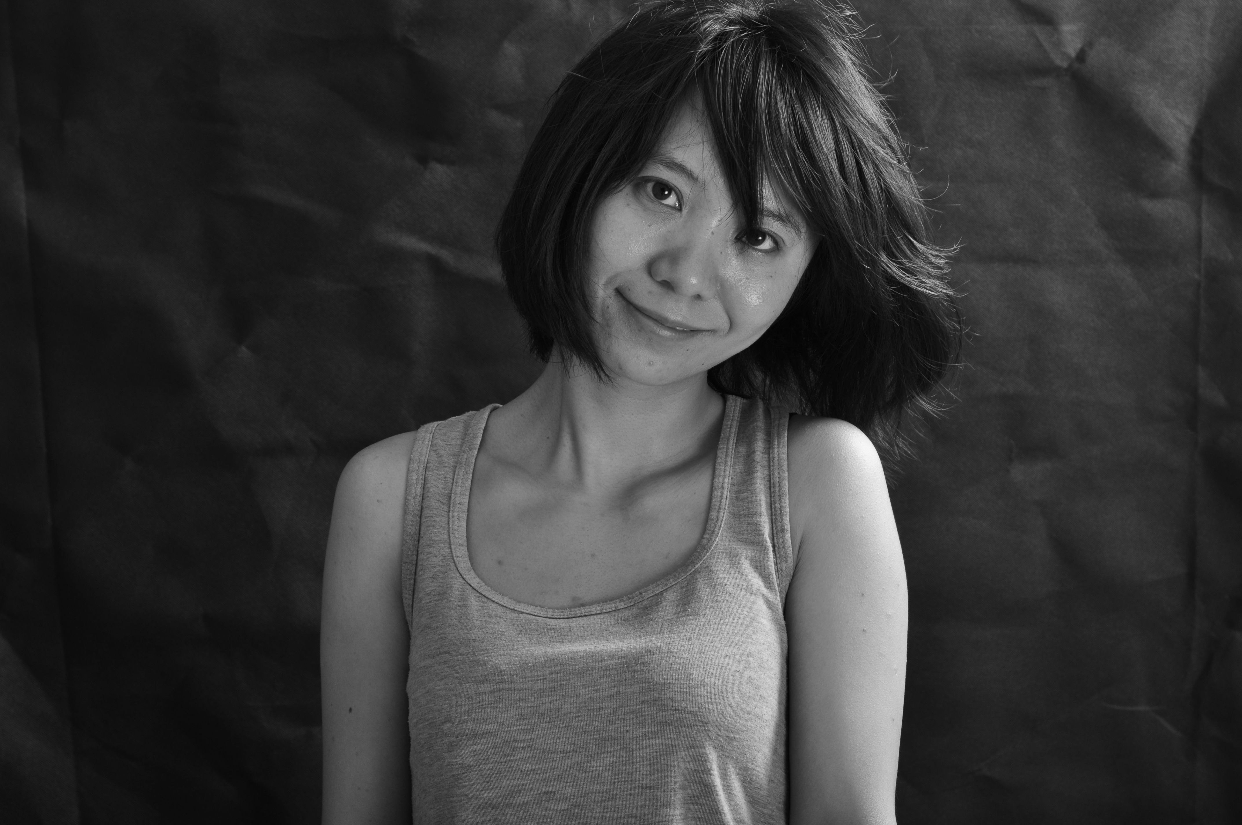Charming black and white portrait of a woman smiling indoors.