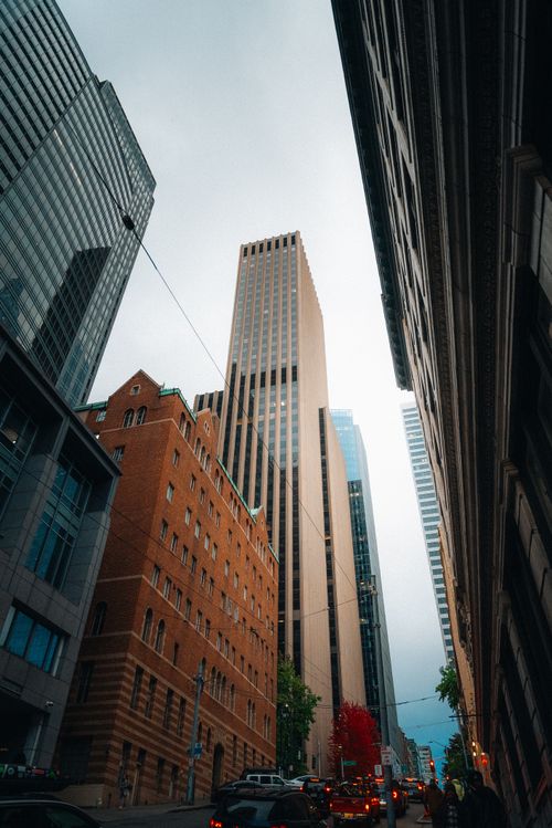 Free A vibrant view of downtown Seattle showcasing tall skyscrapers and classic architecture under a cloudy sky. Stock Photo