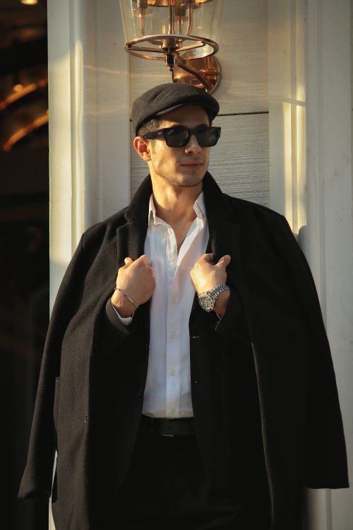 Free Fashionable adult male in sunglasses and coat standing outdoors. Stock Photo