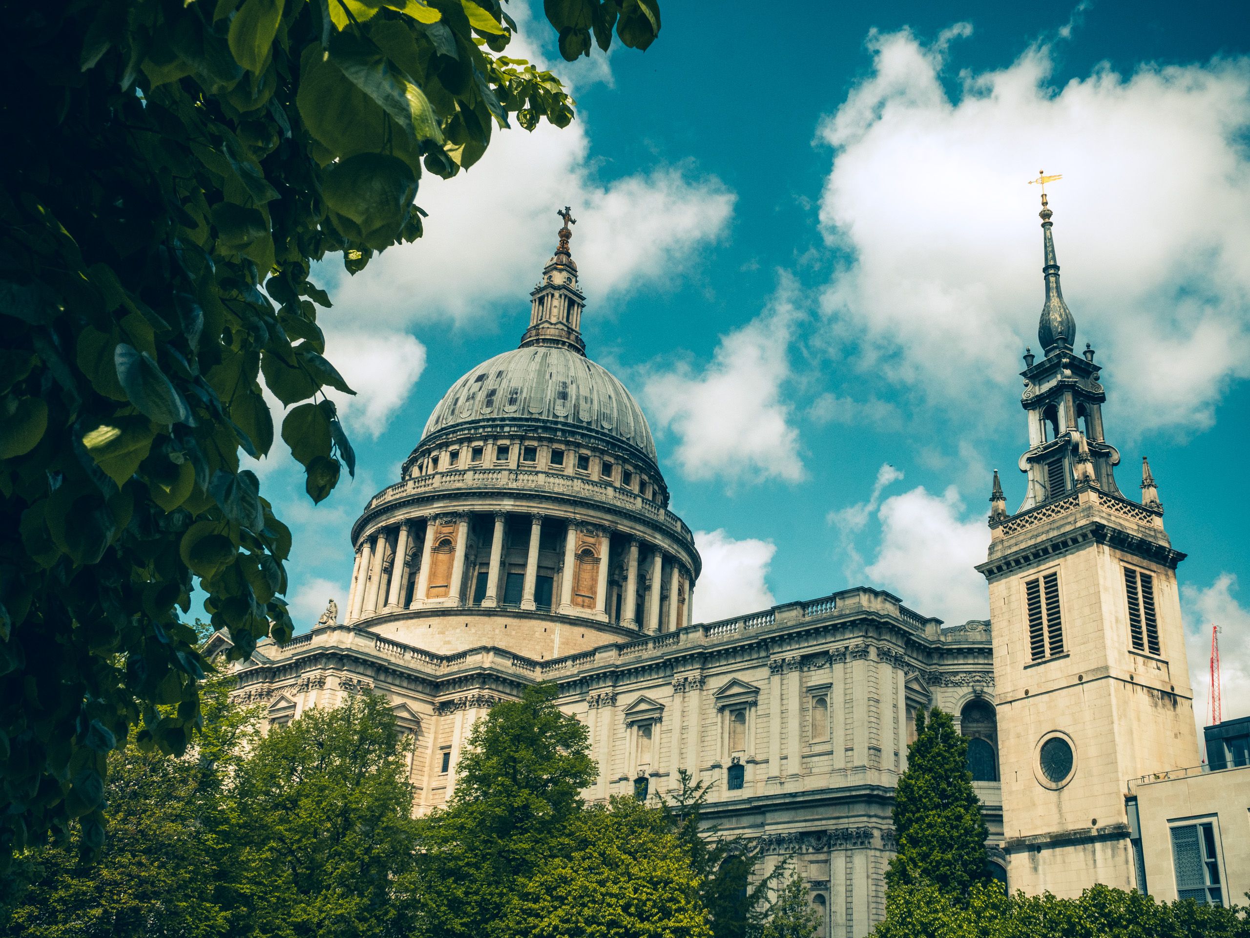 A stunning view of St. Paul's Cathedral in London, captured with lush greenery and a vibrant sky. A stunning view of St. Paul's Cathedral in London, captured with lush greenery and a vibrant sky.