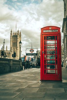 A classic red telephone booth on a London street near Westminster, capturing British charm.
