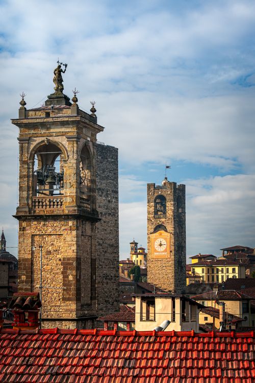 Free Scenic view of medieval bell towers in Bergamo under a blue sky. Stock Photo