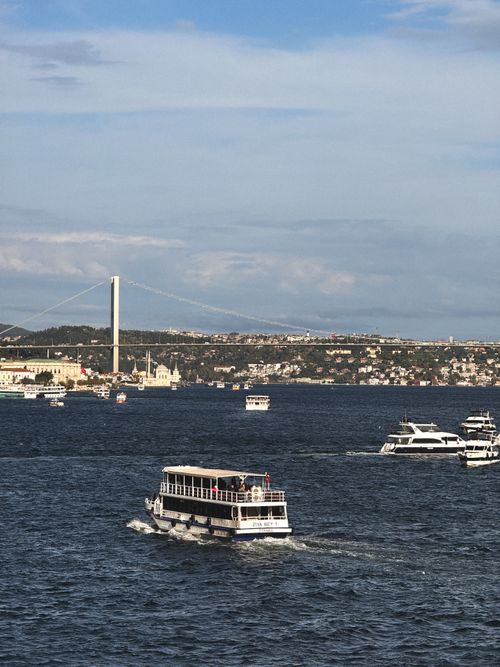 Free View of the Bosphorus Bridge with boats sailing in Istanbul, Turkey. Stock Photo