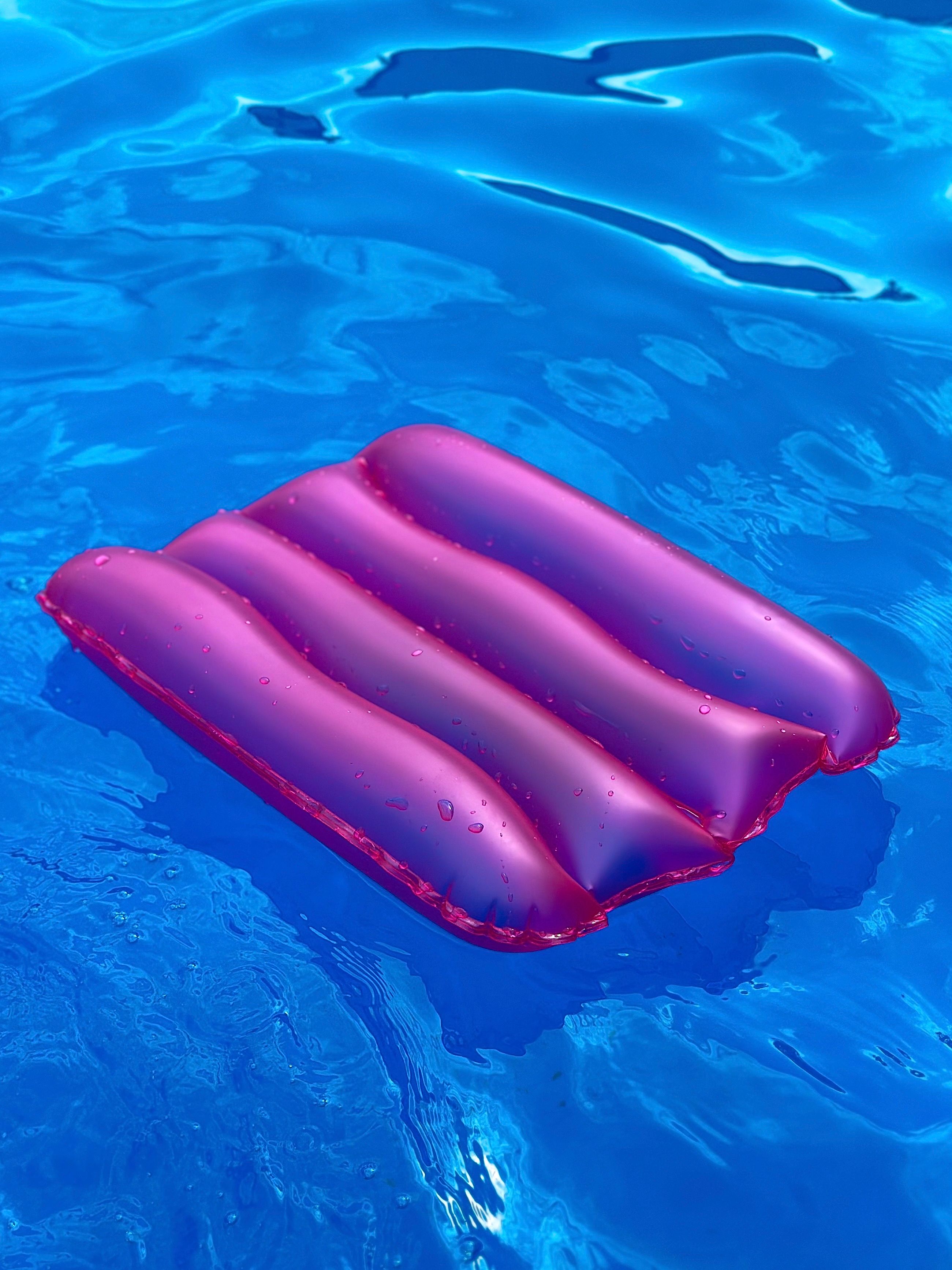 Vibrant Pink Inflatable Float in Blue Pool Water · Free Stock Photo