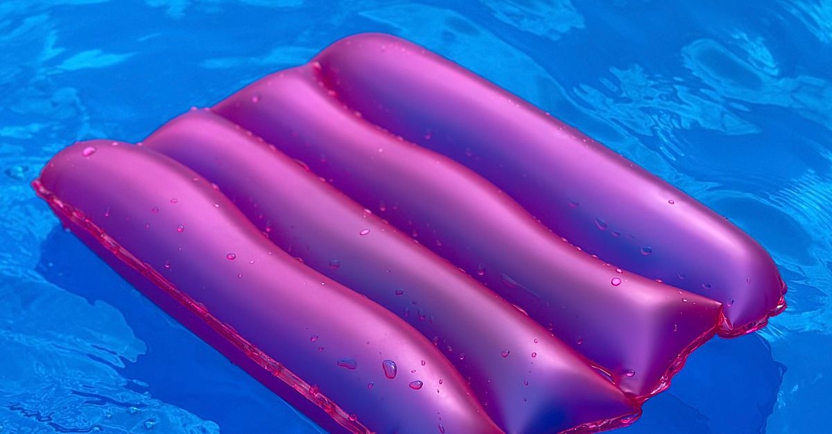 Vibrant Pink Inflatable Float in Blue Pool Water · Free Stock Photo