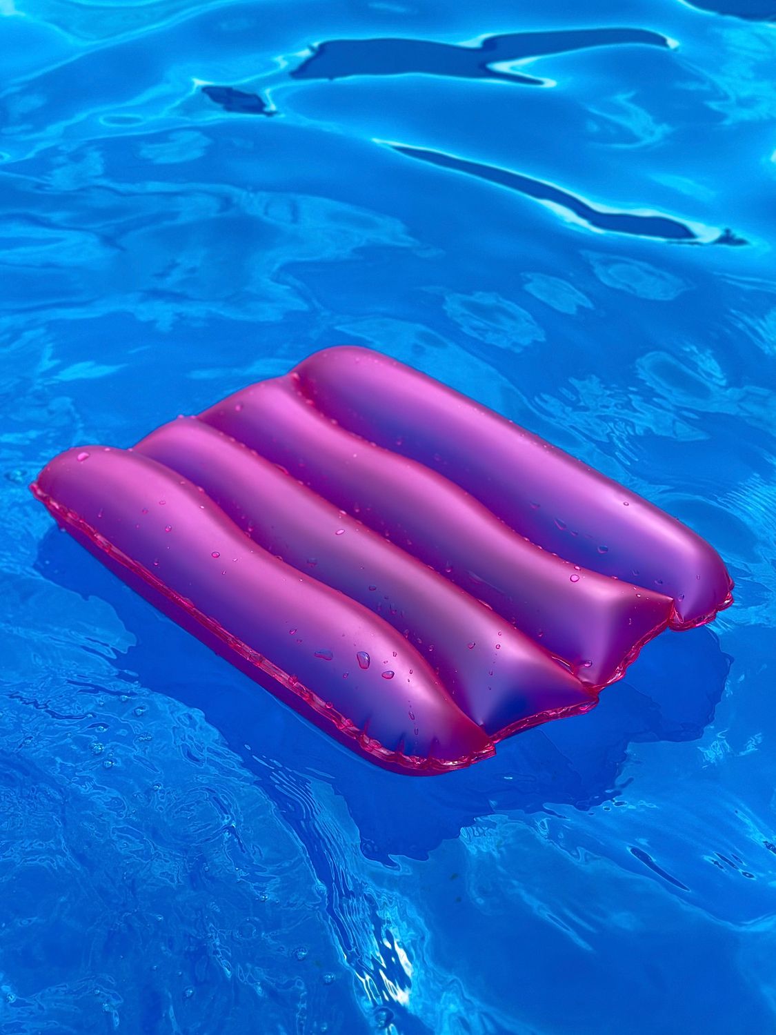 Vibrant Pink Inflatable Float in Blue Pool Water · Free Stock Photo