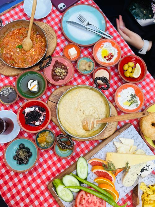 Free Colorful traditional Turkish breakfast spread with diverse dishes on a checkered tablecloth. Stock Photo