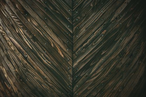 Free Detailed view of a chevron patterned wooden wall showcasing rustic textures and rich color tones. Stock Photo