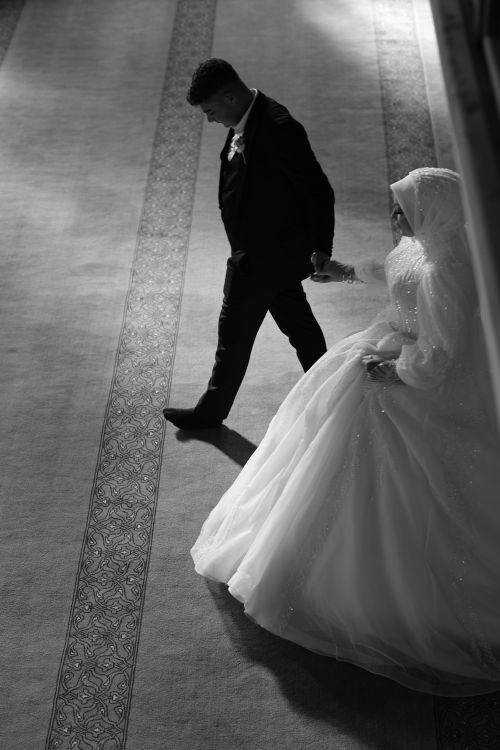 Free Bride and groom walking in elegant black and white wedding photo. Stock Photo