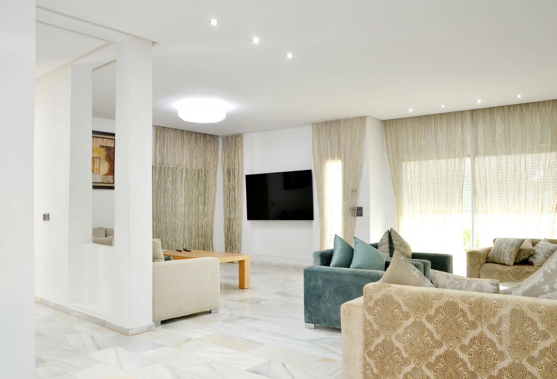 Spacious modern living room with elegant sofas and stylish decor.