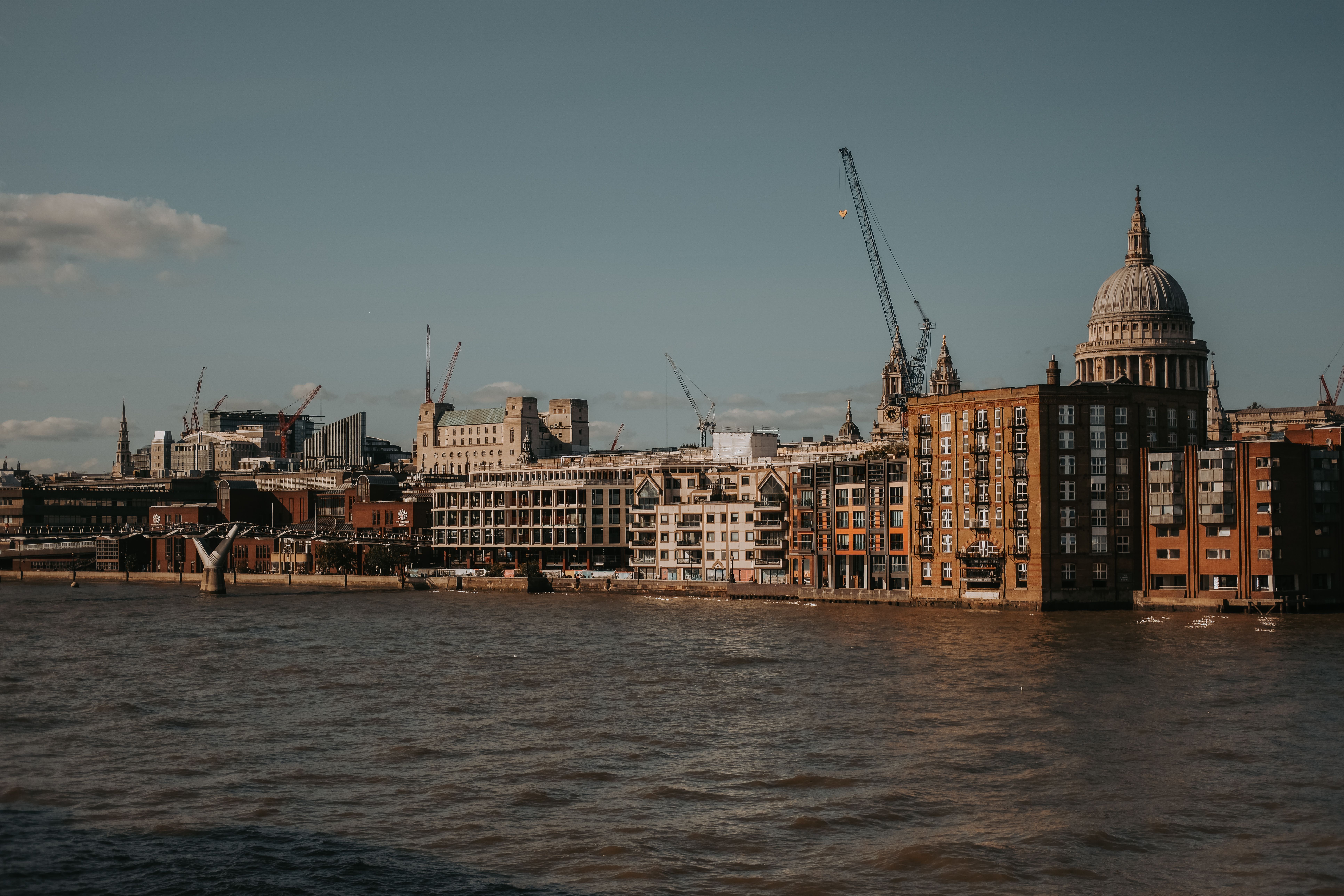 Stunning view of London's riverside architecture featuring St. Paul's Cathedral under a clear sky. Stunning view of London's riverside architecture featuring St. Paul's Cathedral under a clear sky.
