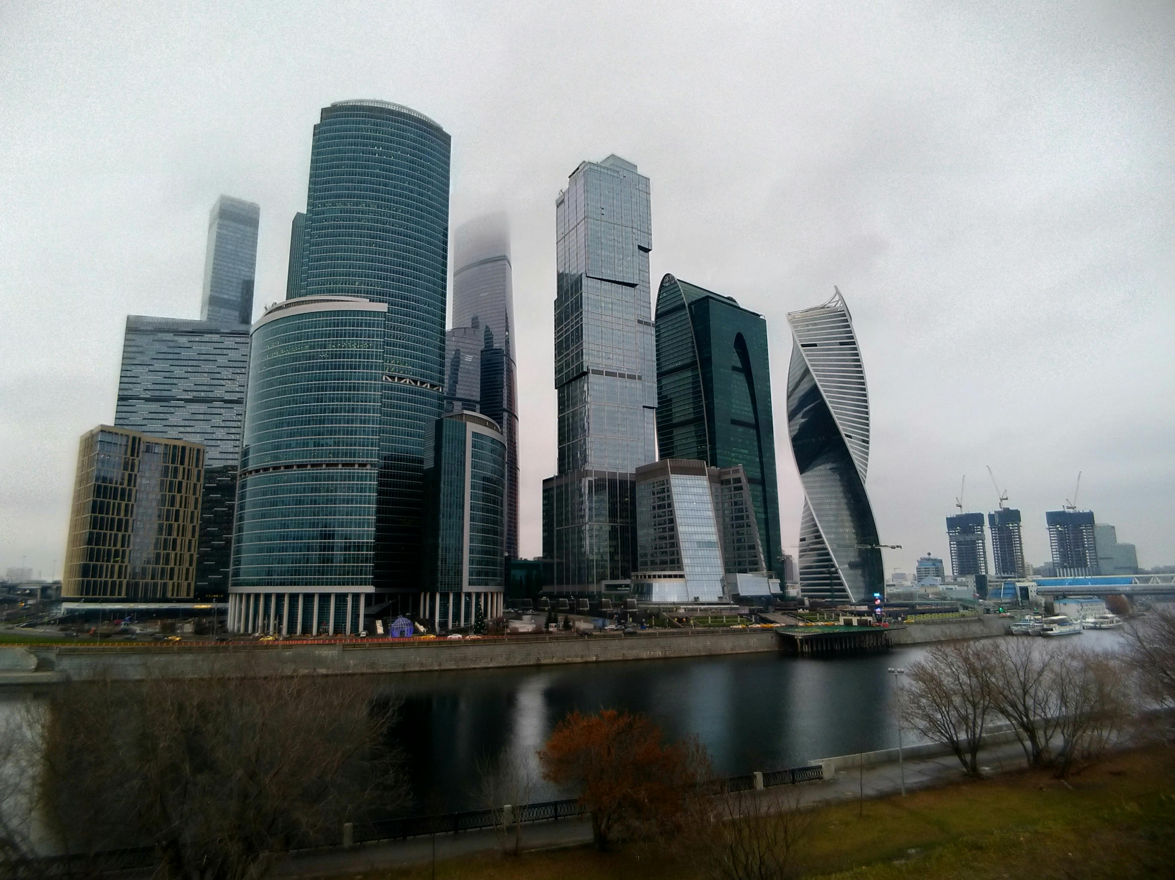 Couple planning vacation with laptop and travel brochures