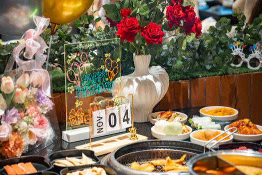Vibrant birthday setting featuring Vietnamese dishes, flowers, and birthday decor with a festive ambiance.