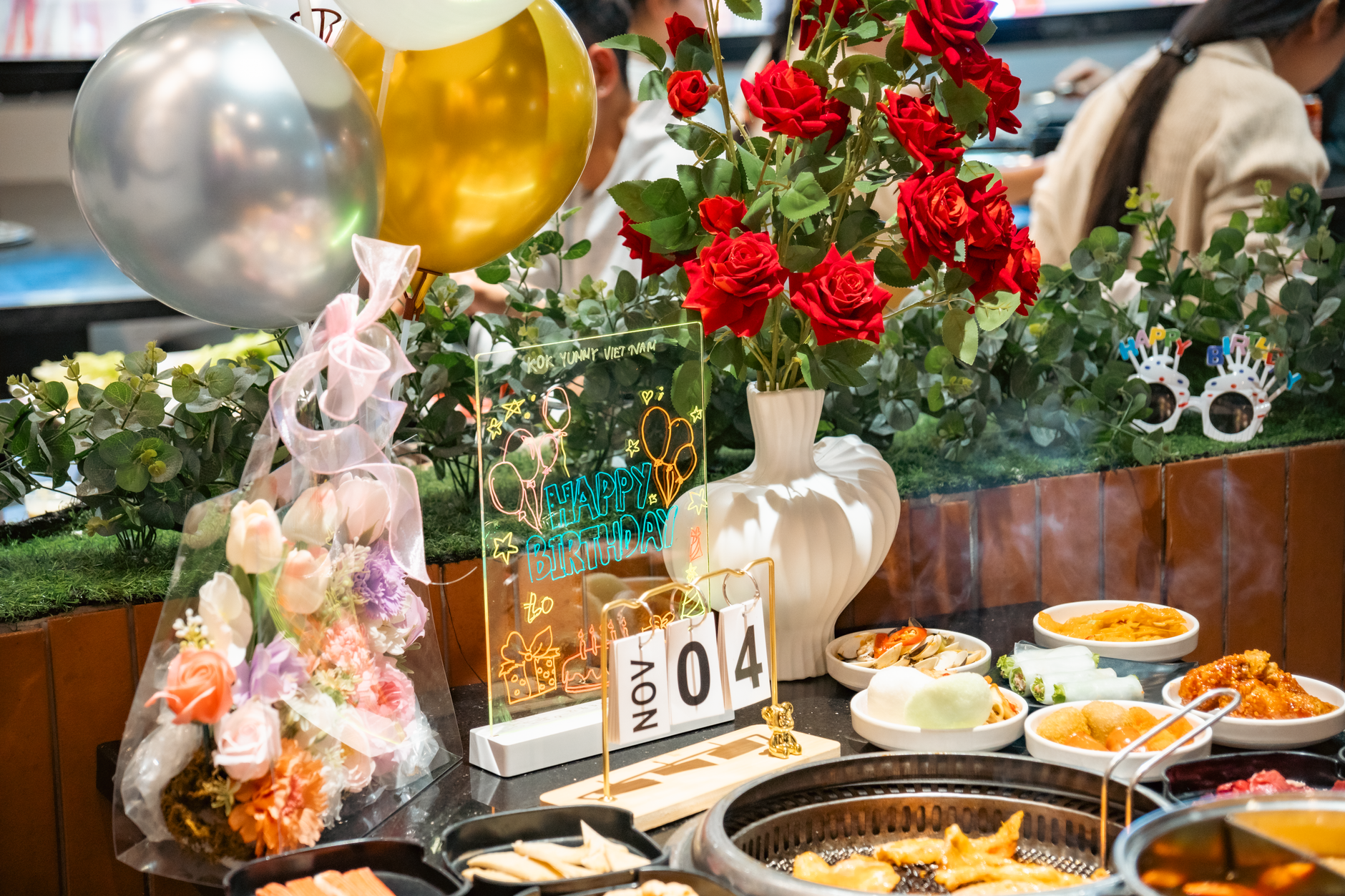 A vibrant birthday celebration featuring Vietnamese cuisine and festive decor.