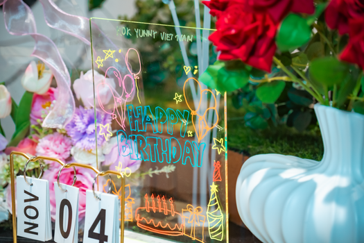 Vibrant birthday greeting with floral decor and date indication.