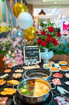 Delightful Vietnamese hot pot setup for a festive birthday celebration in a cozy indoor setting.