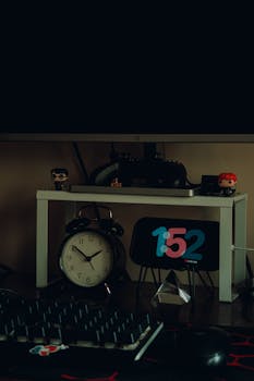 Cozy home workspace featuring a clock, gaming controller, and stylish decor.