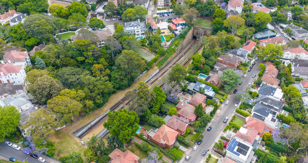 Aerial view of an established Australian suburb of many rooftops, illustrating investment property tax deductions and depreciation