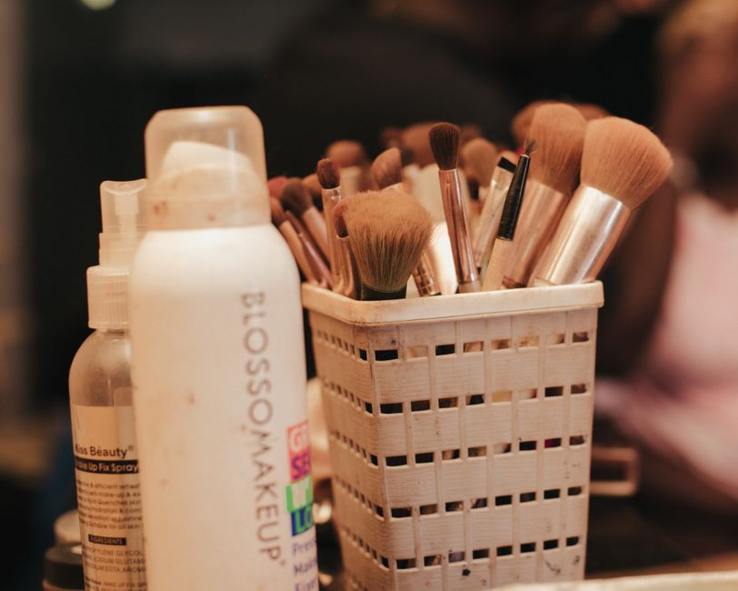 A collection of makeup brushes and beauty products neatly organized in a holder.