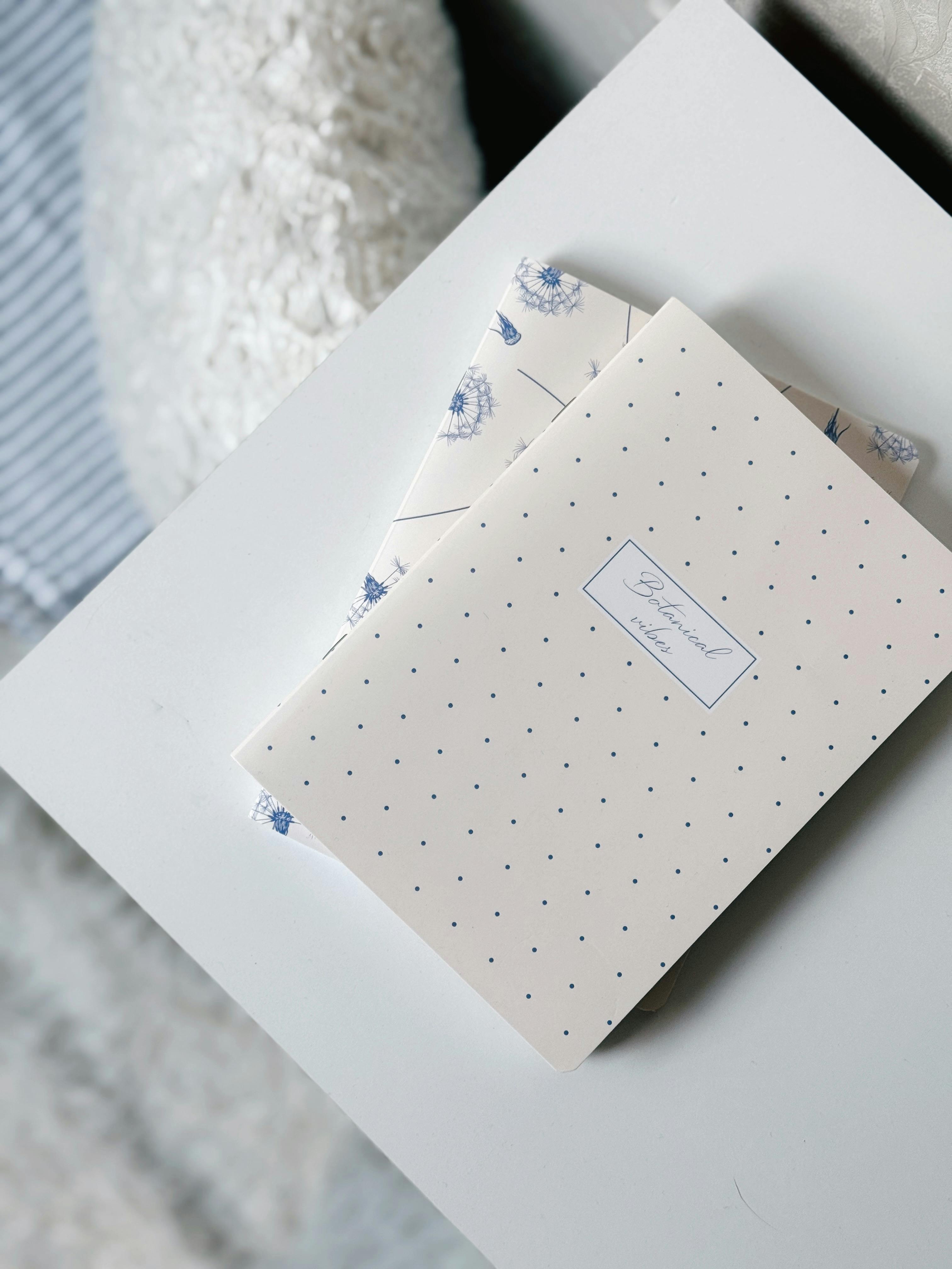Elegant polka dot stationery set on a light desk, ideal for writing letters.