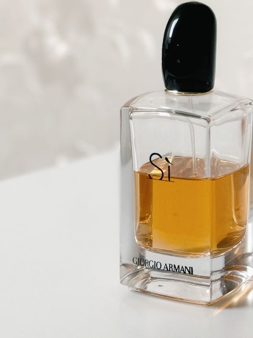 Free Close-up of Giorgio Armani 'Si' perfume bottle on a white table, showcasing luxury design. Stock Photo