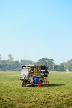 A street vendor operating an auto rickshaw food stall in an open field in Kurigram, Bangladesh.