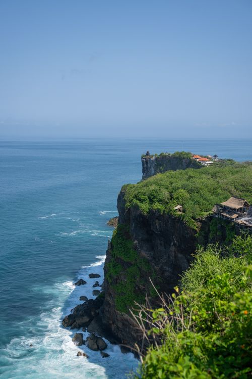 Free Breathtaking view of Uluwatu Temple perched on dramatic cliffs overlooking the ocean in Bali, Indonesia. Stock Photo