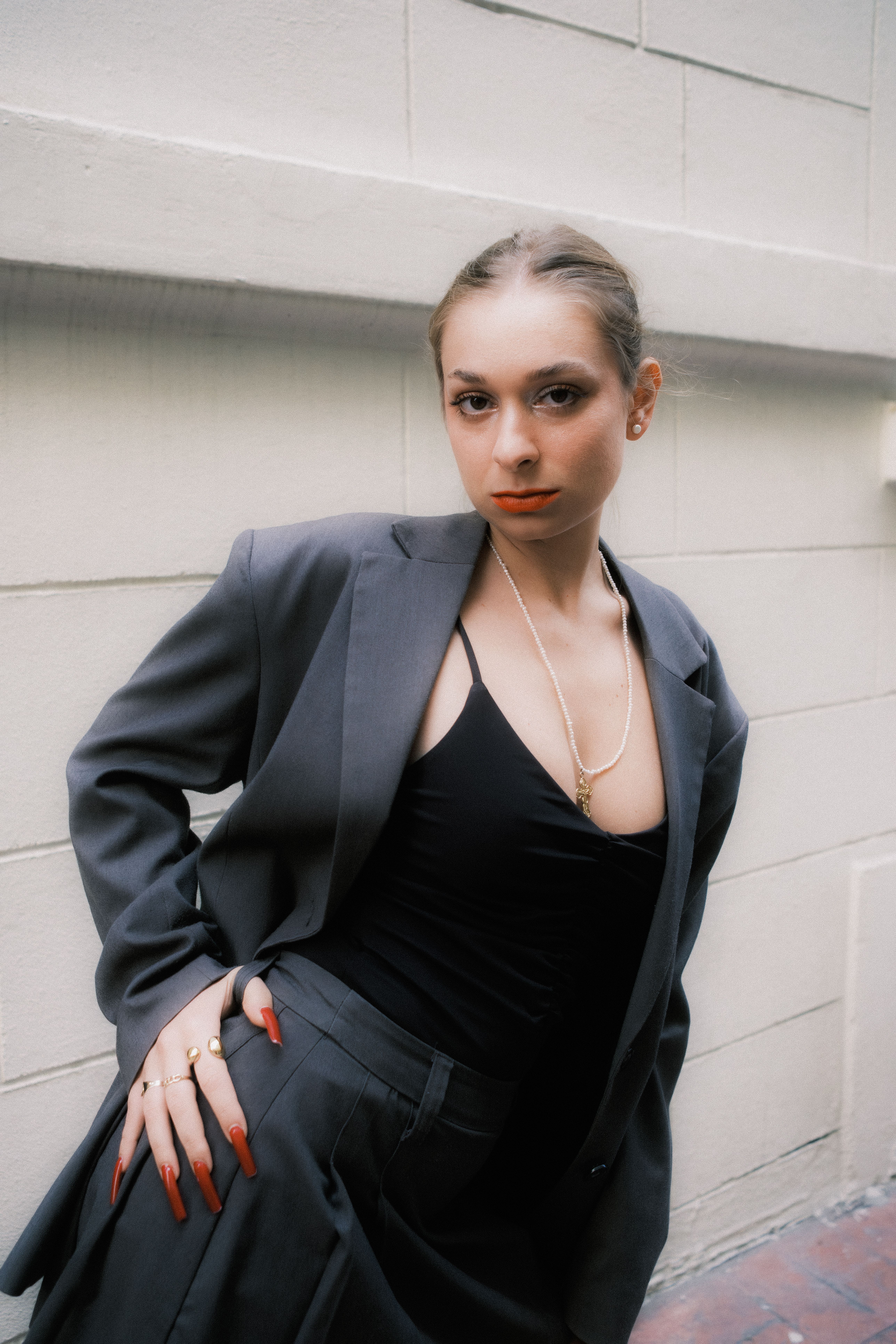 Confident Woman Posing in Stylish Gray Suit · Free Stock Photo