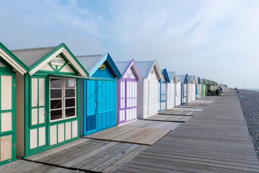 Vibrant beach huts along the boardwalk at Cayeux-sur-Mer, France.